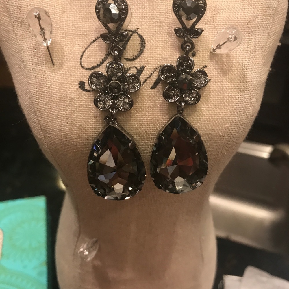 Dark rhinestone earrings set in black