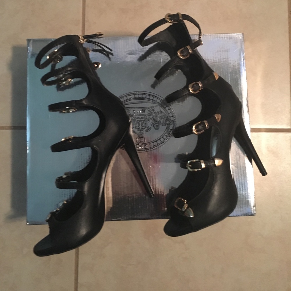 Like new black heels with gold and zipper in back.