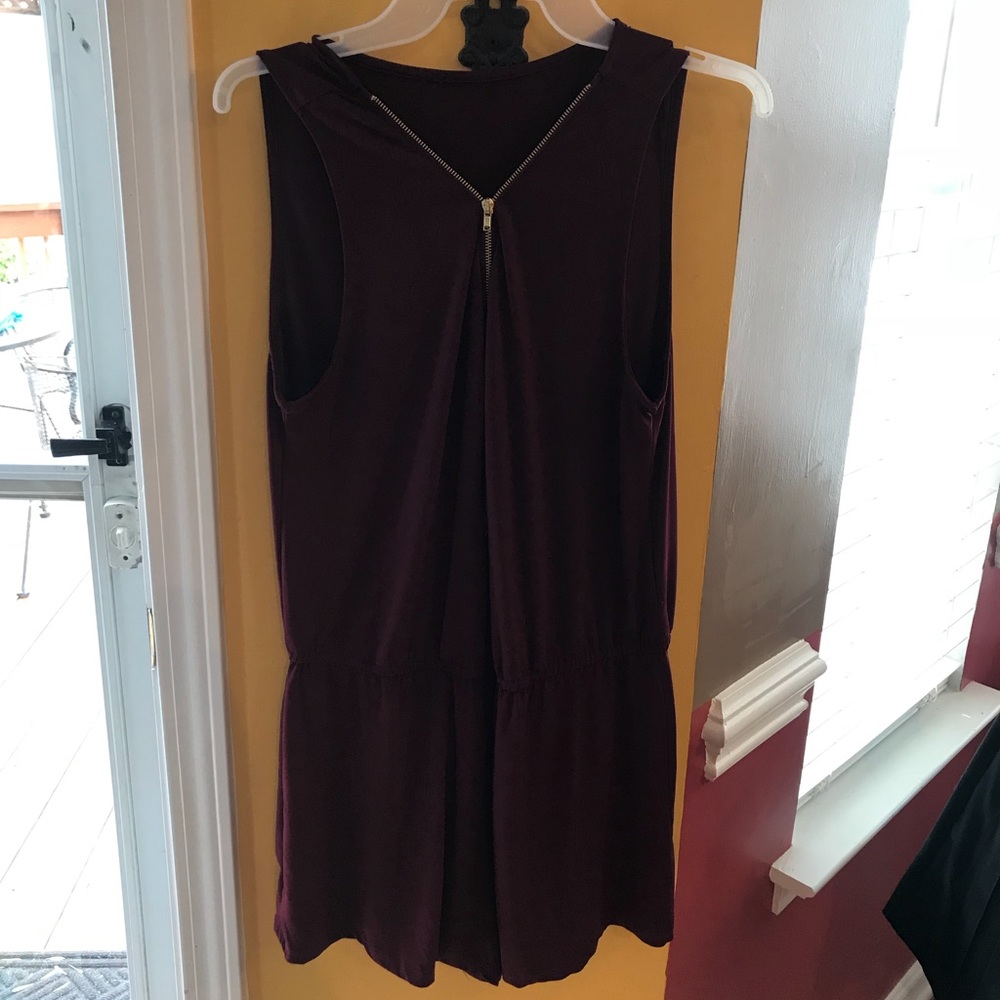 Burgundy romper with gold zipper in the front