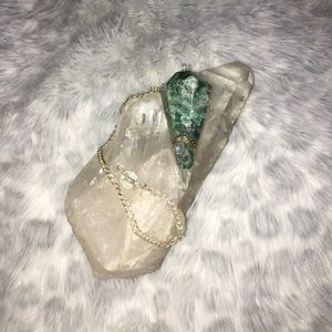 Green and gold stones in resin pendulum