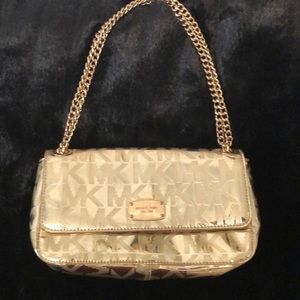 Michael Kors gold purse with MK logo