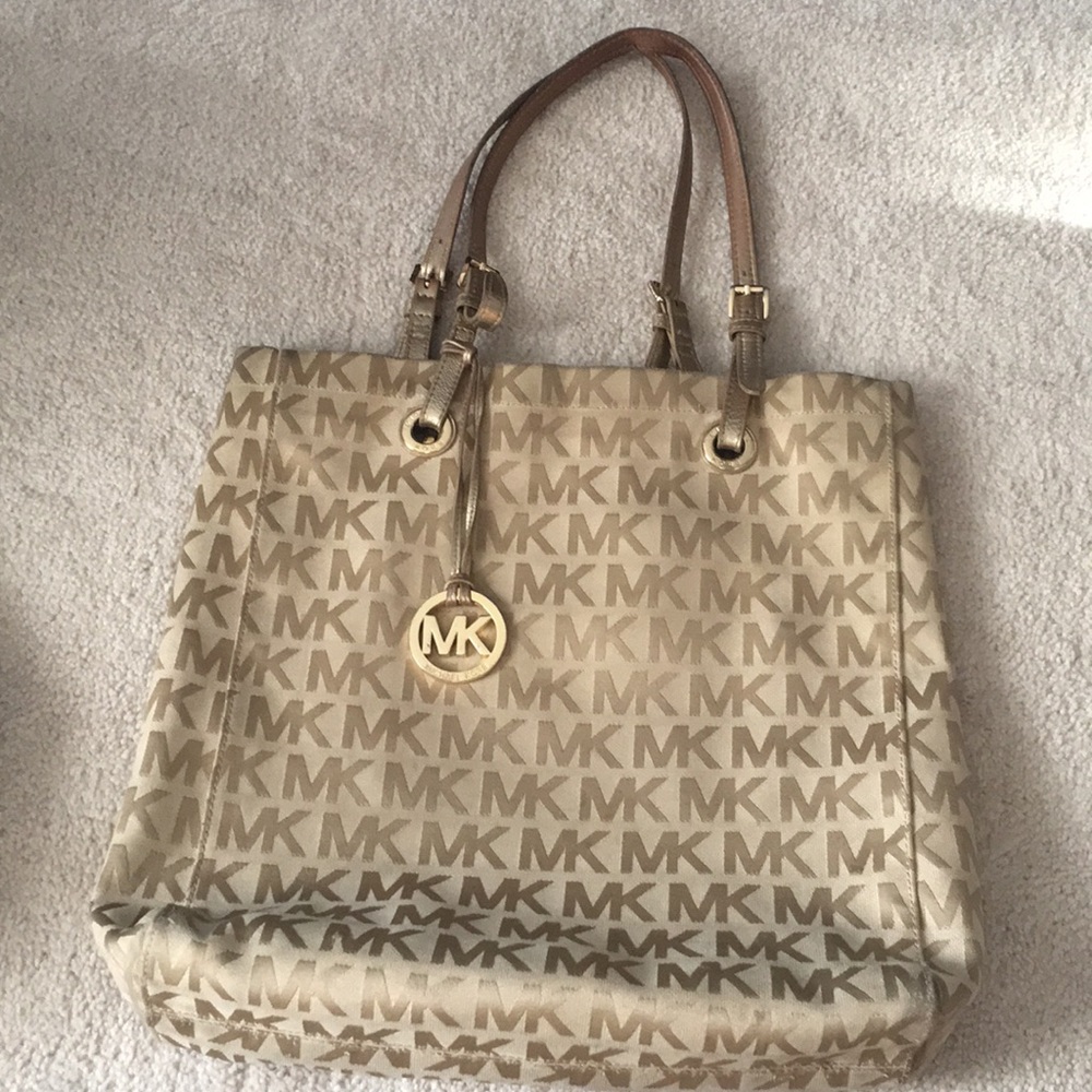 Gold and beige Michael Kors travel bag
