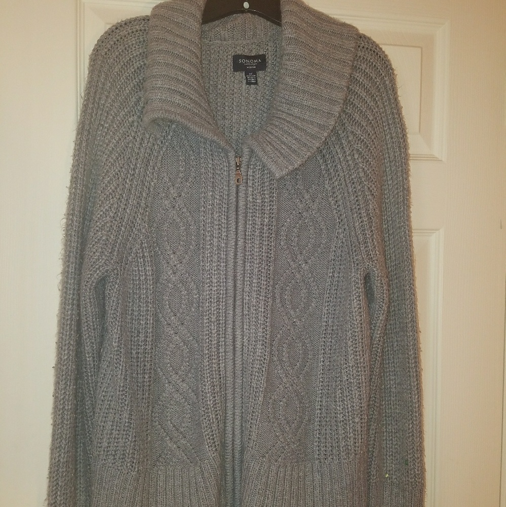 Gray sweater with a large collar.