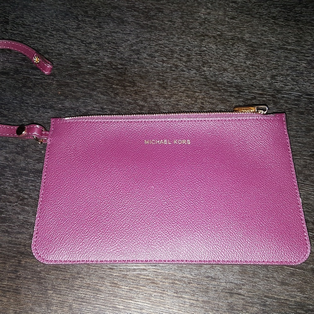 Michael Kors plum color clutch.