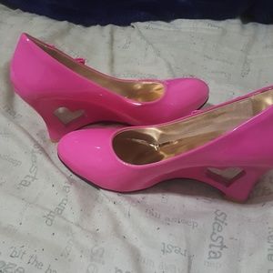 Pair of PU high heels with heart cutout heel