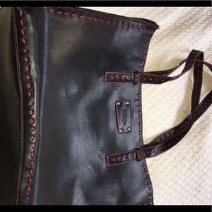EUC black leather bag with red stitching accents