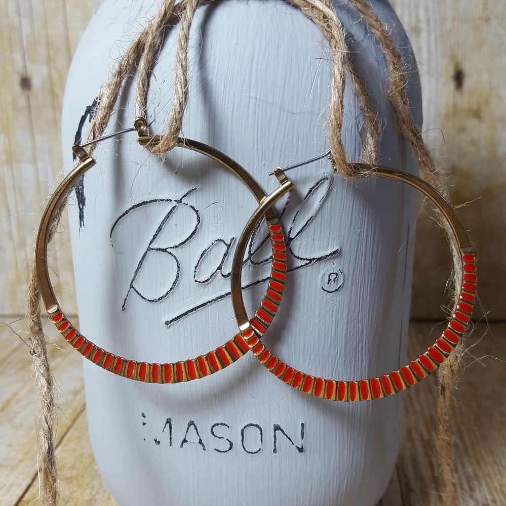 NWOT. Red and gold tone hoop earrings.