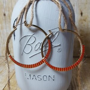 NWOT. Red and gold tone hoop earrings.