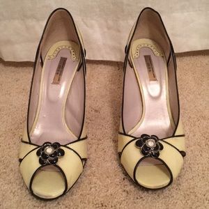 Cream and black open toe pumps