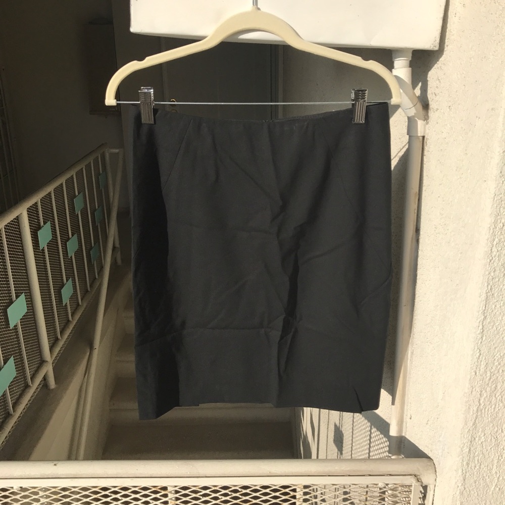 Black pencil skirt. Slightly stitched up.