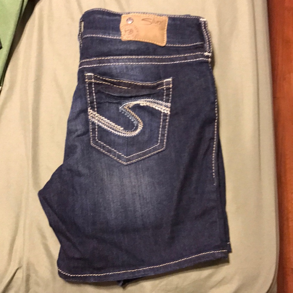 Mid length silver jean shorts.