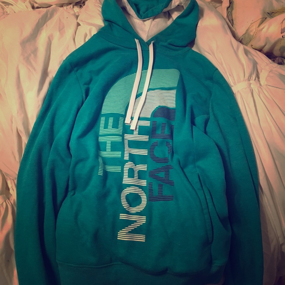 A turquoise The North Face hoodie