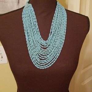 Turquoise colored beaded necklace.