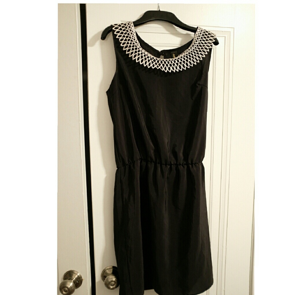 Dress with decorated neckline