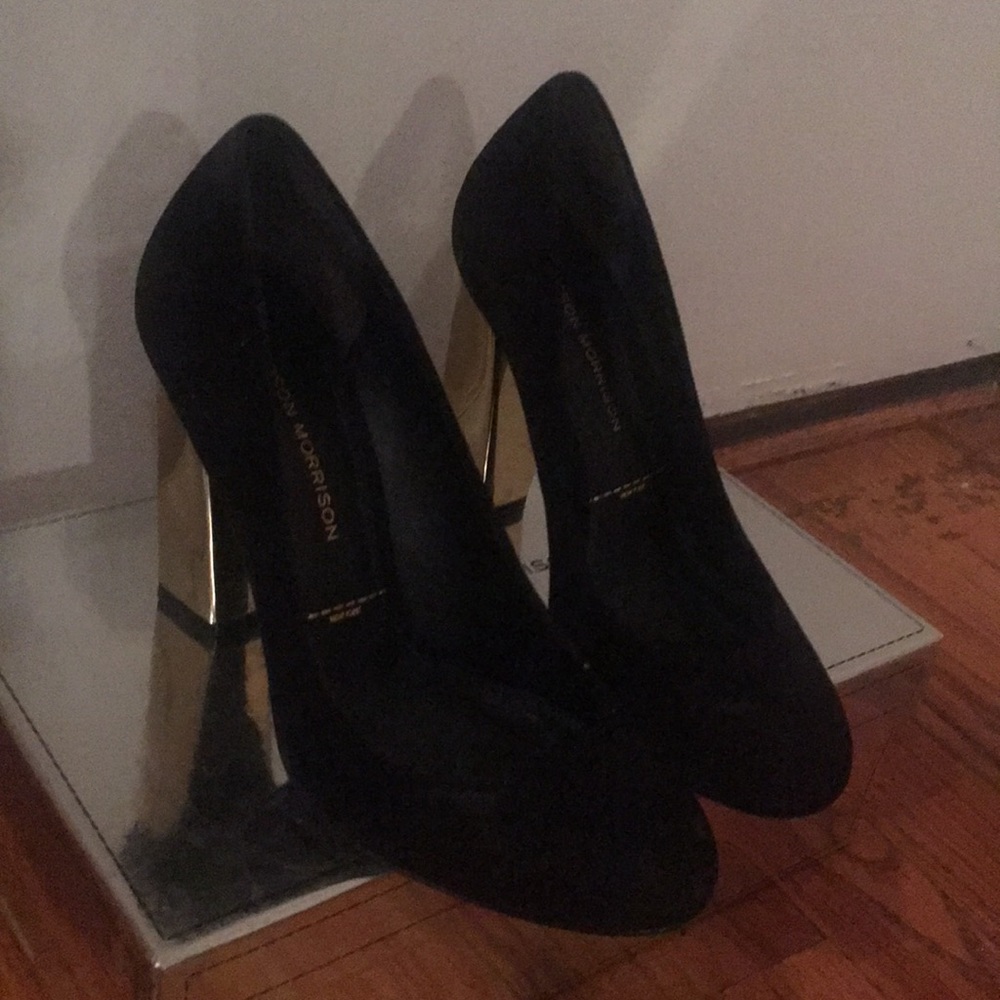 Black velvet pumps with gold metallic heel.