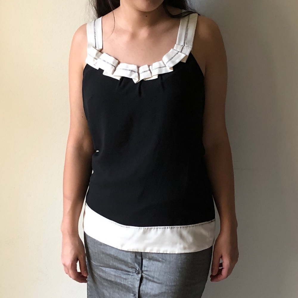 Black sleeveless top with white hem