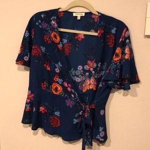 Dark teal and floral flutter sleeve wrap top