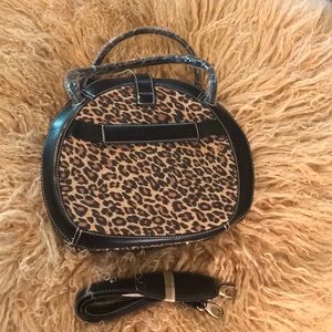 Leopard print bag with adjustable strap.