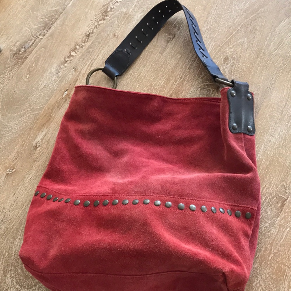 Red suede shoulder bag.