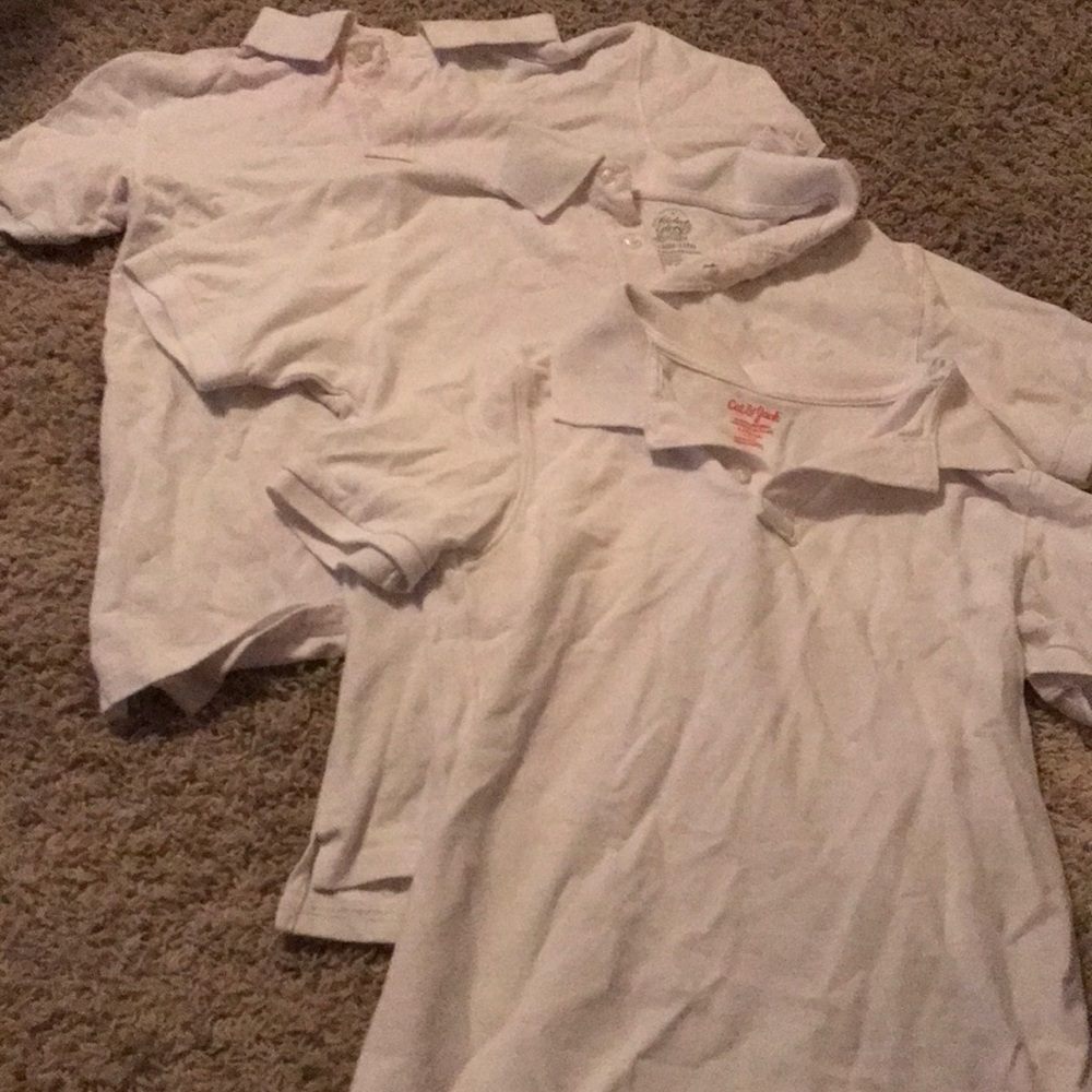 three plain white collared button down shirts