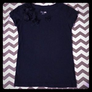 Cherokee top with flower embellishments.