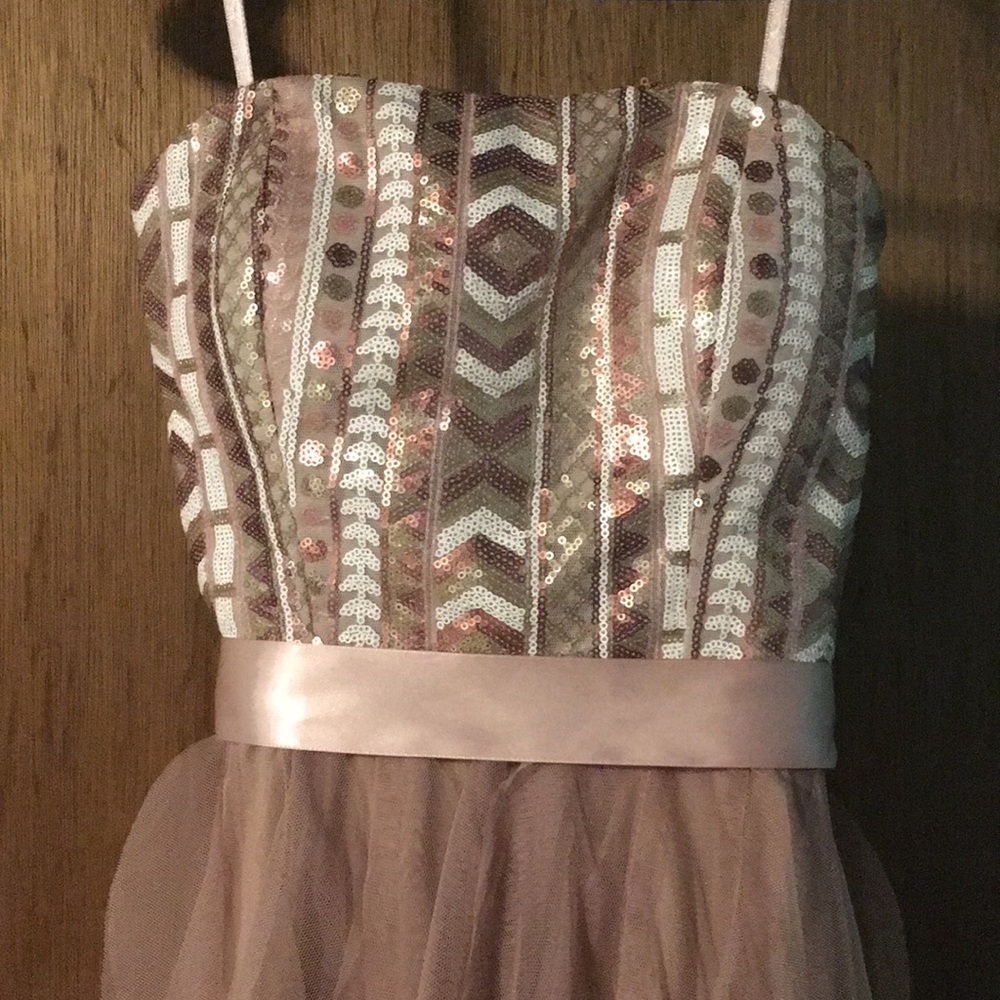 Sleeveless long back and short in the front dress.