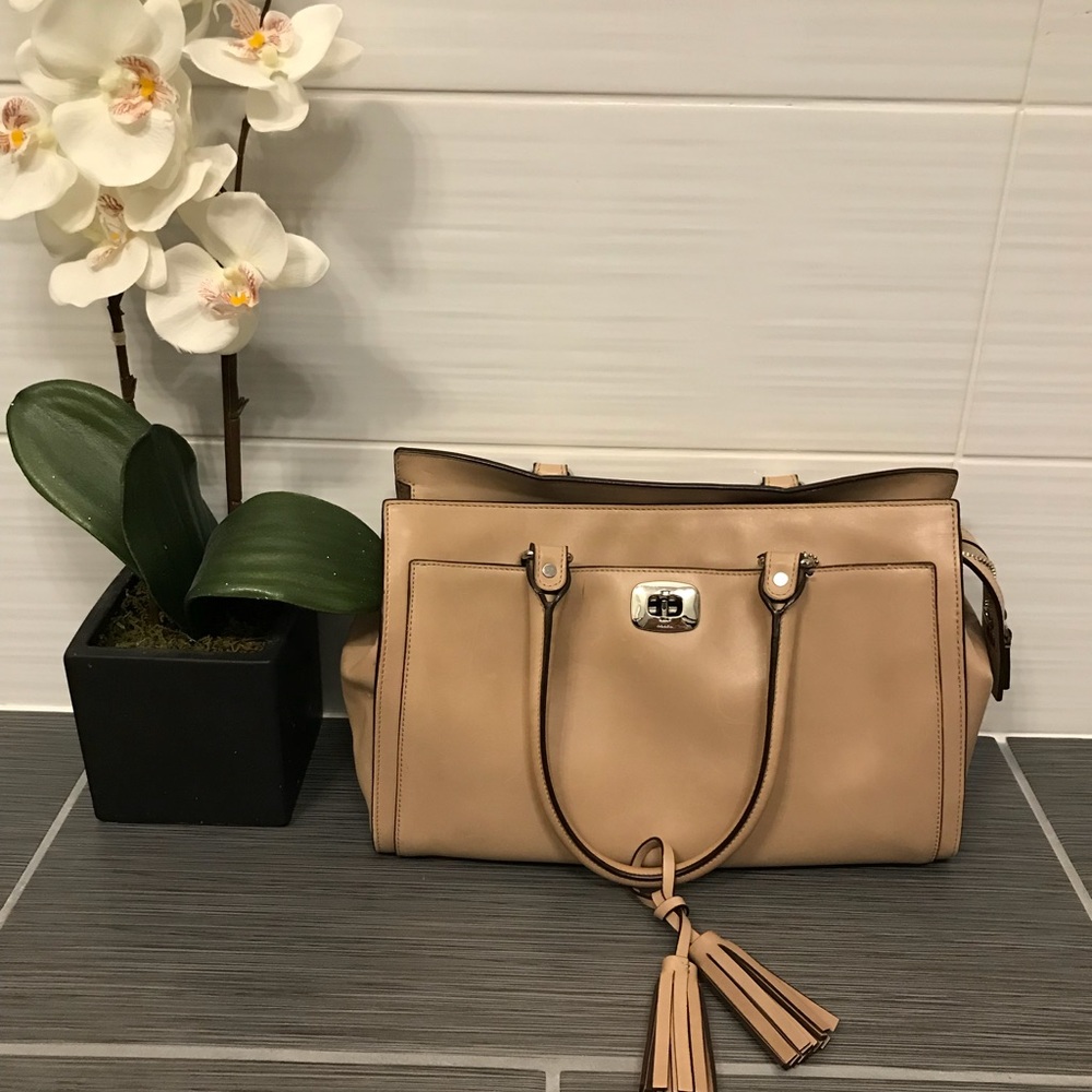 This is a cream coach purse