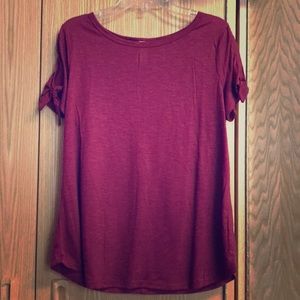 Burgundy colored shirt.
