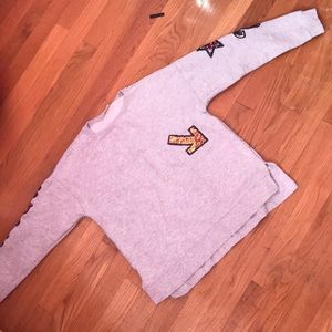 A gray sweater with  sequence