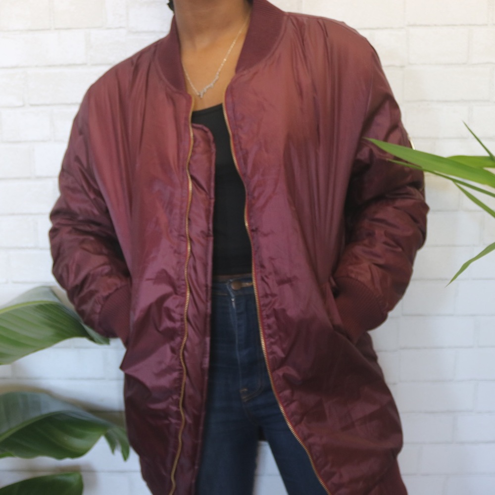 Burgundy bomber jacket with gold zippers
