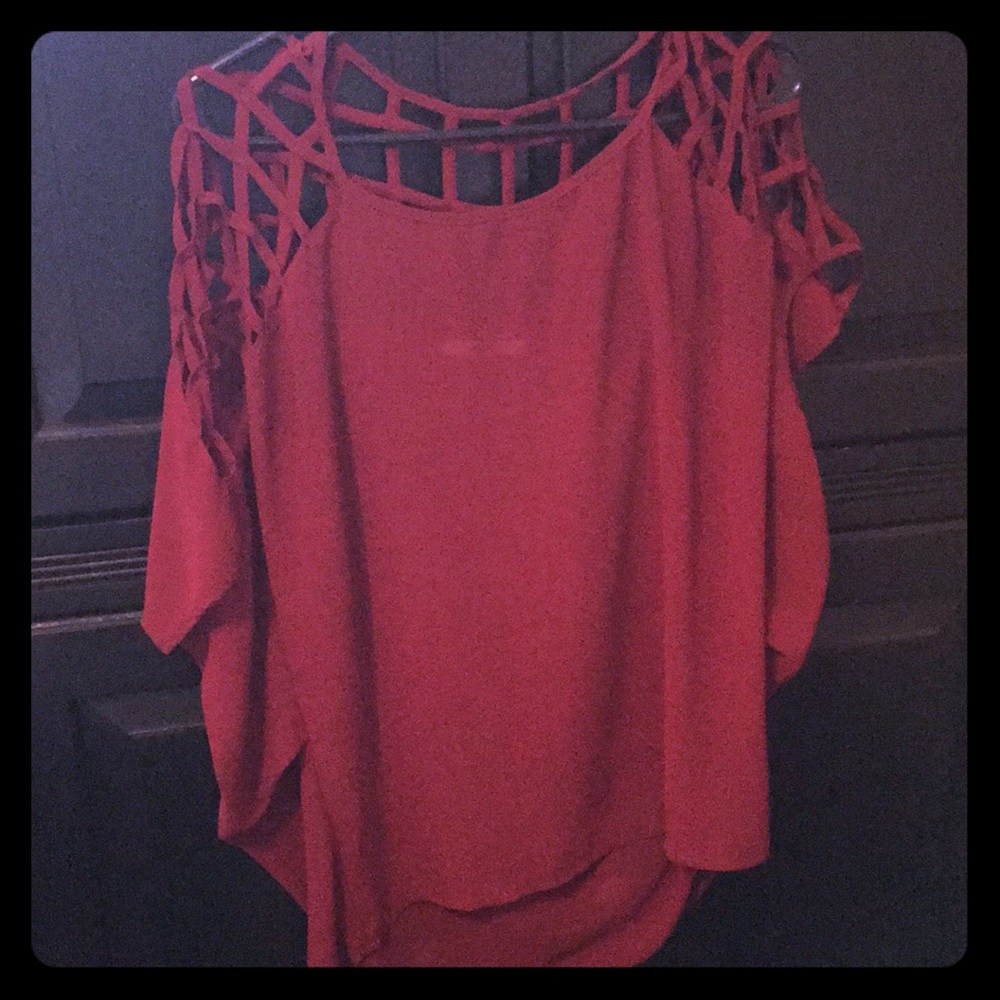 See-through maroon shirt with detailed cut outs.