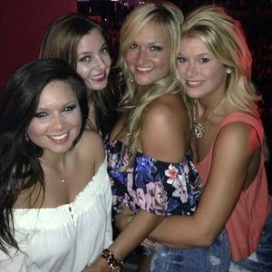 Off-the-shoulder black floral crop top.