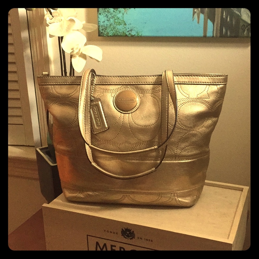 Gold leather signature “C” Coach tote.