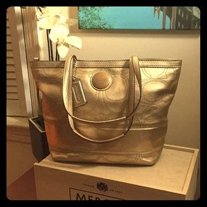 Gold leather signature “C” Coach tote.
