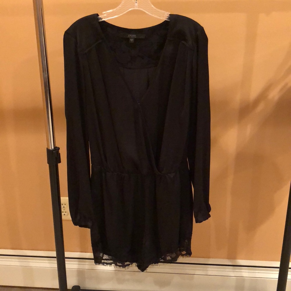 Black romper with lace detail.