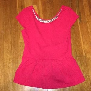 Red peplum top with beaded neckline