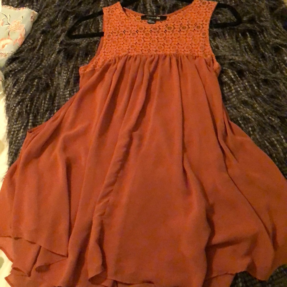 Women’s burnt orange colored short sleeved blouse