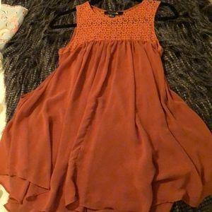 Women’s burnt orange colored short sleeved blouse