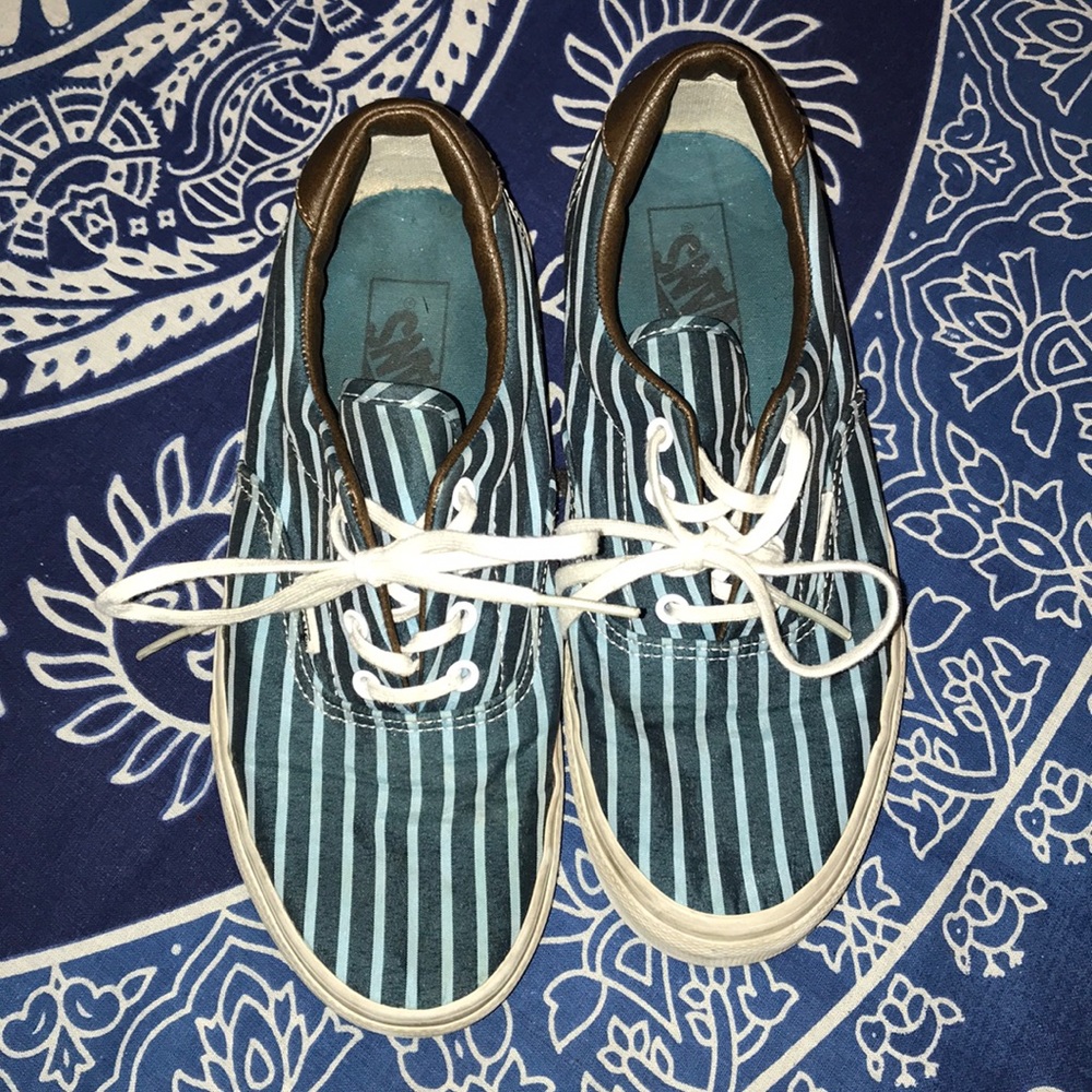 Striped blue vans w/ brown leather around the top