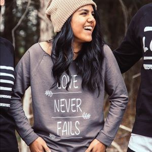 Love Never Fails Women’s Sweatshirt, scoop neck.