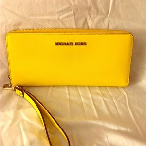 Yellow Michael Kors wallet with wrist strap
