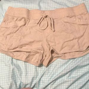 Tan shorts with pockets in front and back. Size L.