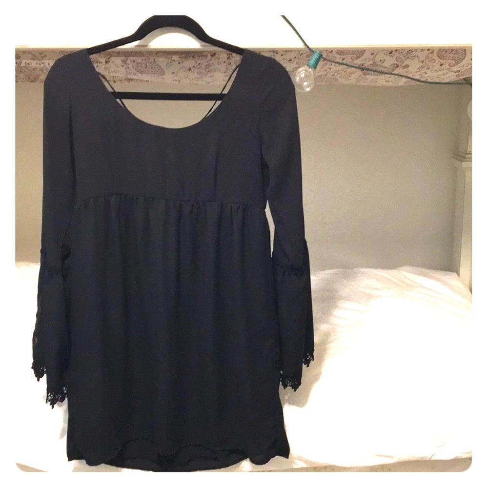 Black dress with bell sleeves and lace hem
