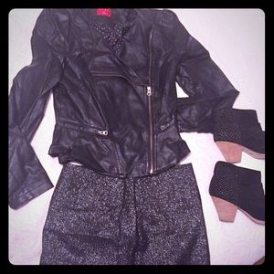 Elle non-leather, fitted black jacket with ruffle.