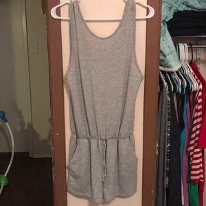 Grey romper never worn! With pockets. Size L.