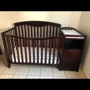 Crib with changing bed and side compartments