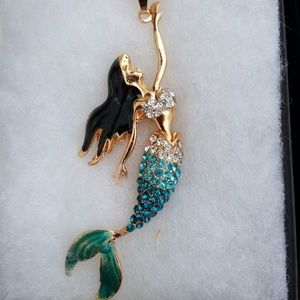 Mermaid pendant with gold tone necklace