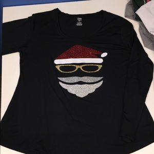 Long sleeve shirt with glitter Santa image on it.