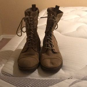 Lace up brown boots.