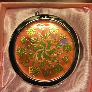 Beautiful feminine pink mirror compact in box.